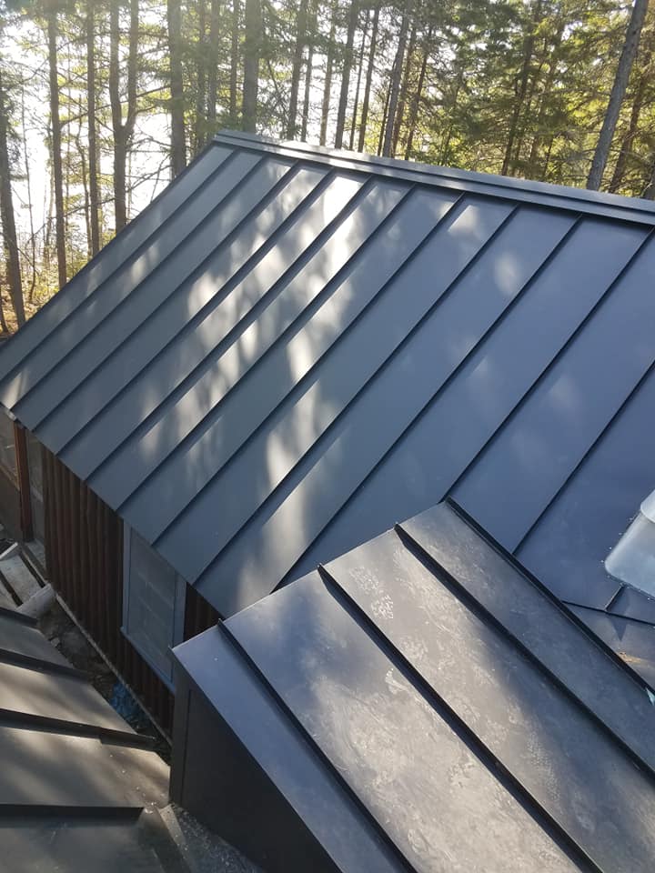 Black seam metal roofing from top of house