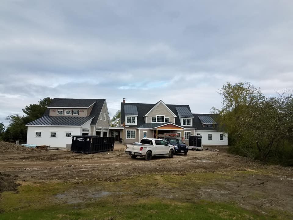 Combination asphalt and metal roofing for large house and garage new construction